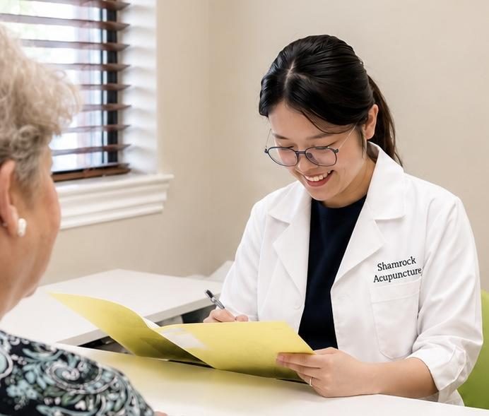 Shamrock Xu reviewing notes with a patient in the clinic